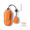 Suede car key cover protector shown in cement grey, dark green, light grey, and orange colours.