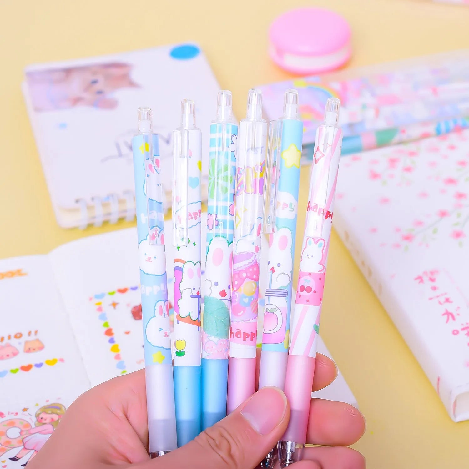 Six plastic ballpoint pens with cartoon bunny design showing 0.5mm tips and neutral black ink