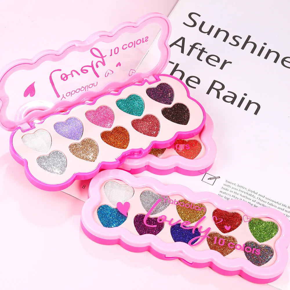 Ten-colour eye shadow palette with pearlescent heart and sequins finishes in a compact.