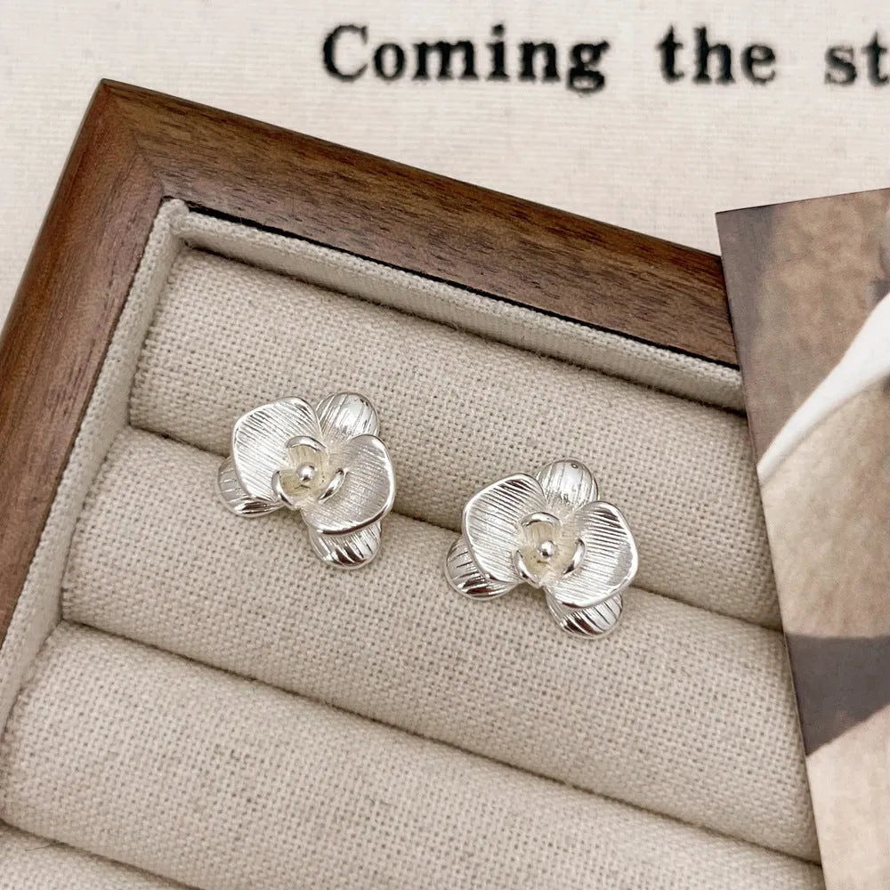 Women's retro floral copper earrings with electroplated gold or silver finish showing petal flower design
