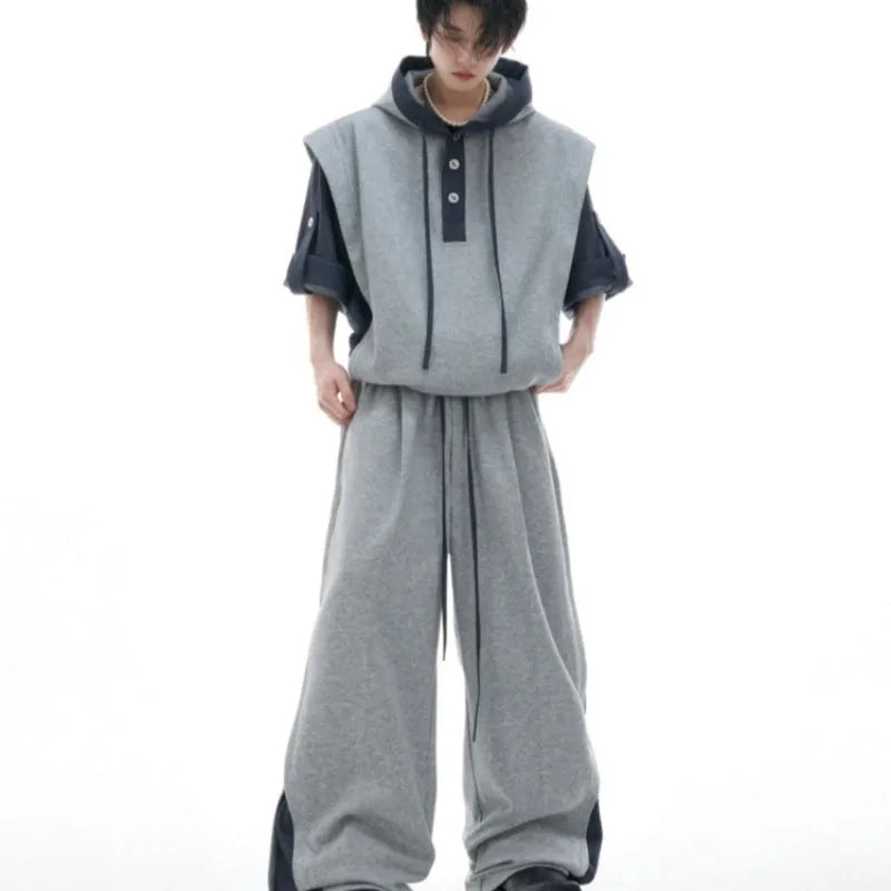 Men's black polyester sports suit with hooded jacket featuring three-dimensional stitching and matching trousers