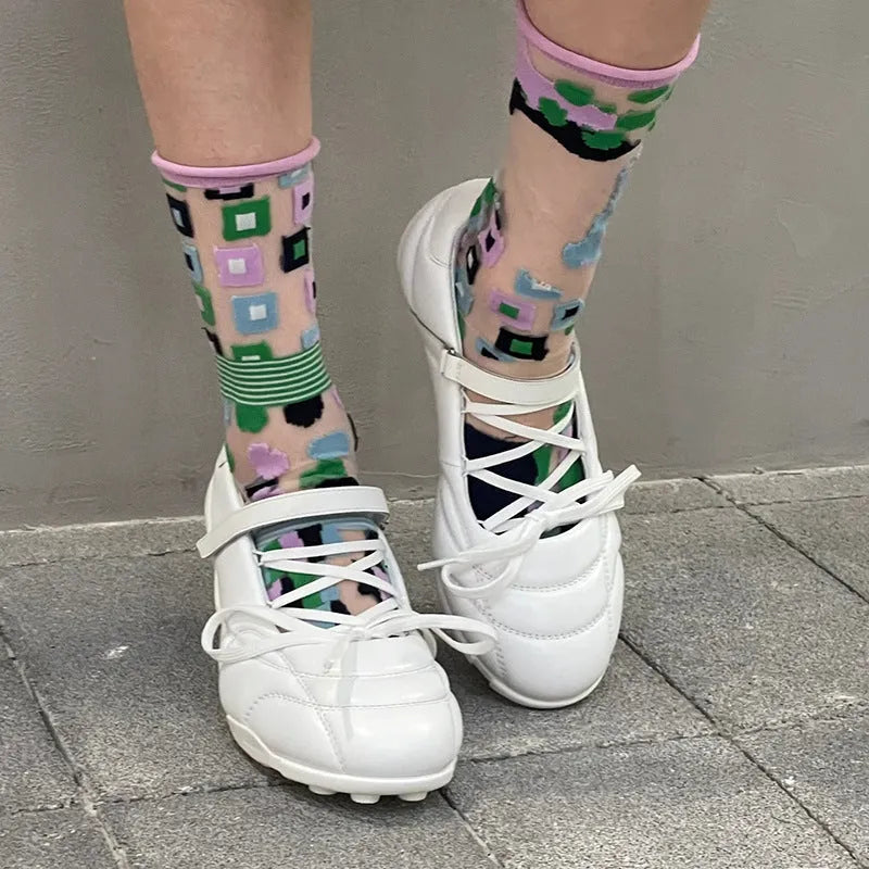 Women's silver lace-up bow sports shoes with a round toe and mid heel on a white background