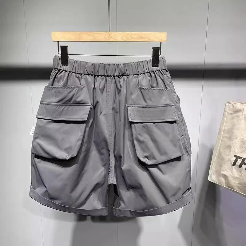 Men's loose fit workwear shorts in black or grey with pockets and straight leg hem available in large sizes