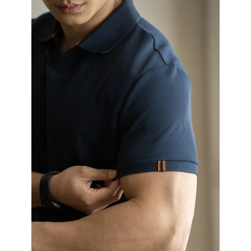Blue short-sleeved cotton blend polo shirt on a hanger, showing regular fit and button placket.