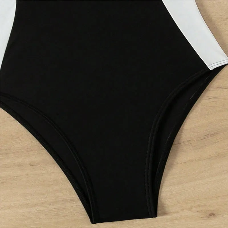 Black and white women's one-piece swimsuit with pearl spaghetti straps, sleeveless design