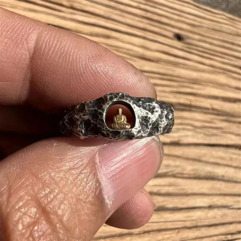 Hand-forged copper Grotto Buddha ring with rock texture on a size 8 finger.