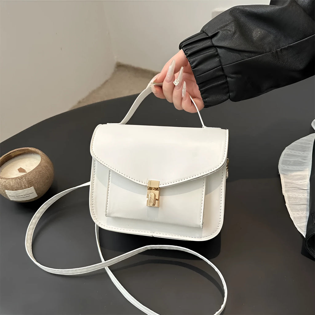 Shoulder messenger bag in horizontal square shape with sewing line detailing and crossbody strap
