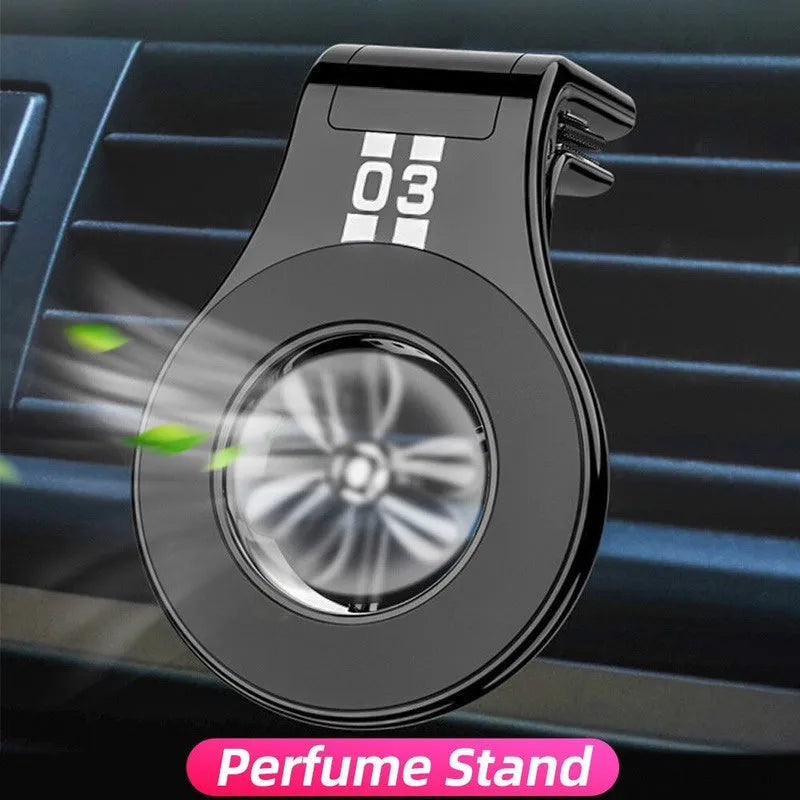 Black magnetic car phone holder clipped to car air vent with smartphone attached and fragrance pads