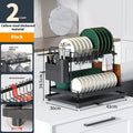 White double-tier metal kitchen storage rack holding pots and pans.