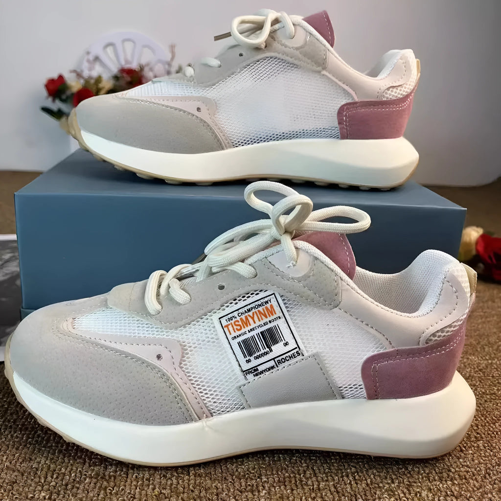 Women's gray retro sneaker with mesh lining and rubber sole on wooden floor