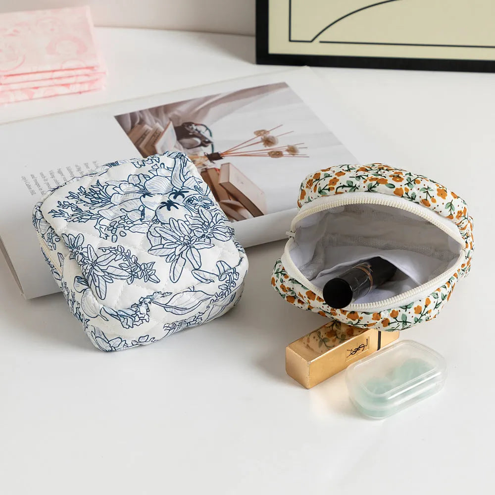 Polyester women's key storage bag with floral pattern choices on white background.