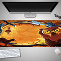 Oversized Halloween-themed gaming mouse pad on a desk, showing non-slip rubber cloth base.