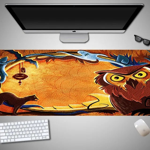 Oversized Halloween-themed gaming mouse pad on a desk, showing non-slip rubber cloth base.