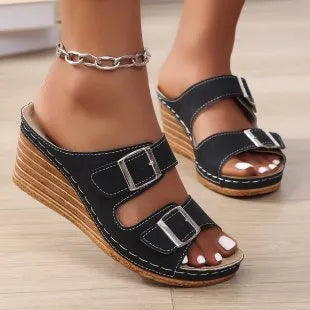 Women's beige wedge heel slippers with a decorative outer buckle fastening on a rubber sole