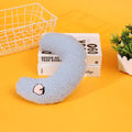 Blue U-shaped half moon pillow with cartoon dog print for pet carriers and cages.