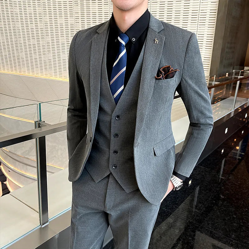 Men's slim fit black business suit jacket and trousers on a hanger.