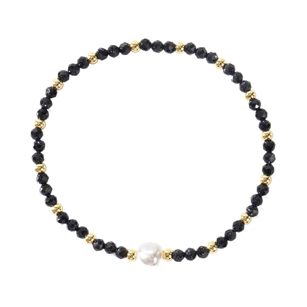 A natural stone bracelet with a geometric ellipse shape on a wrist.