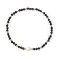 A natural stone bracelet with a geometric ellipse shape on a wrist.
