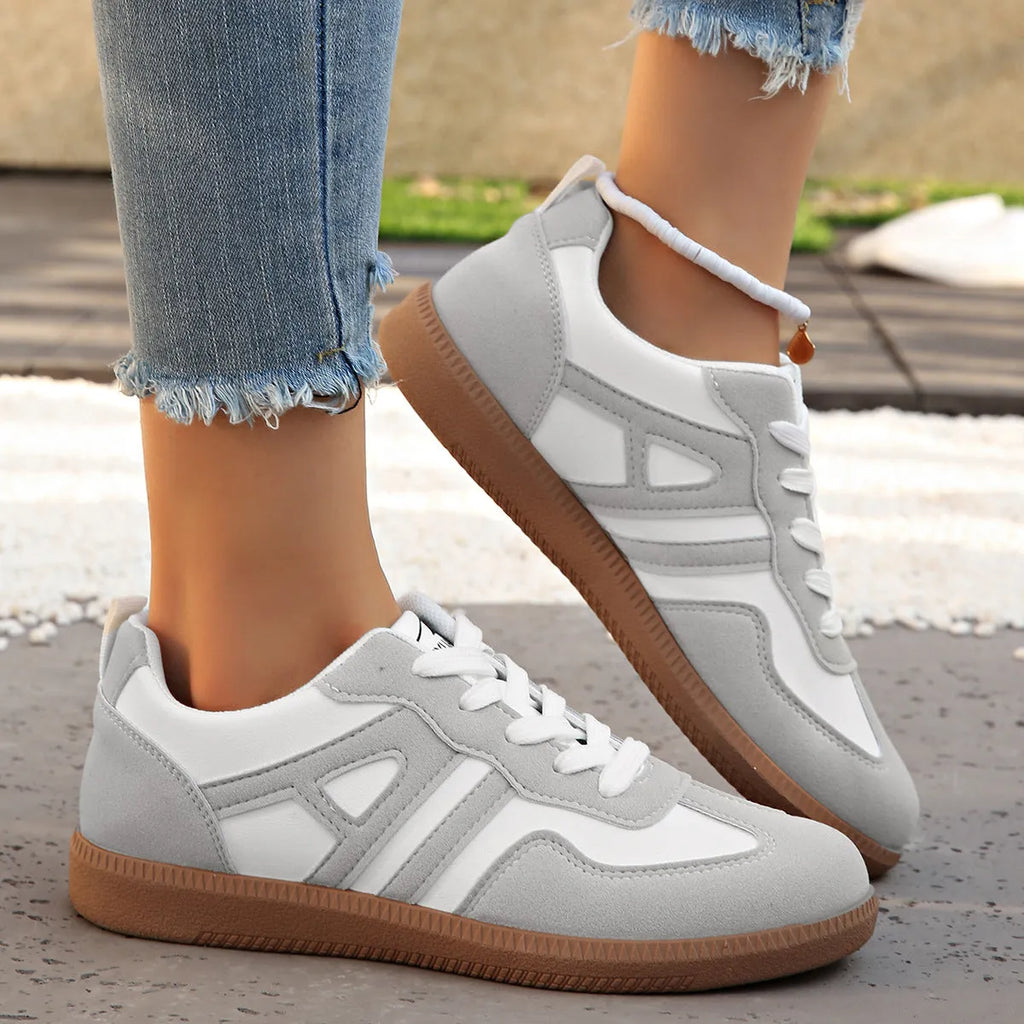 Women's retro colour matching lace-up jogging shoes in grey, showing cross-strap detail and platform sole.