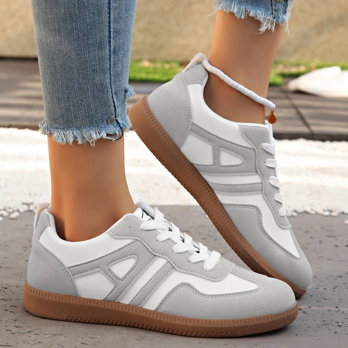 Women's retro colour matching lace-up jogging shoes in grey, showing cross-strap detail and platform sole.