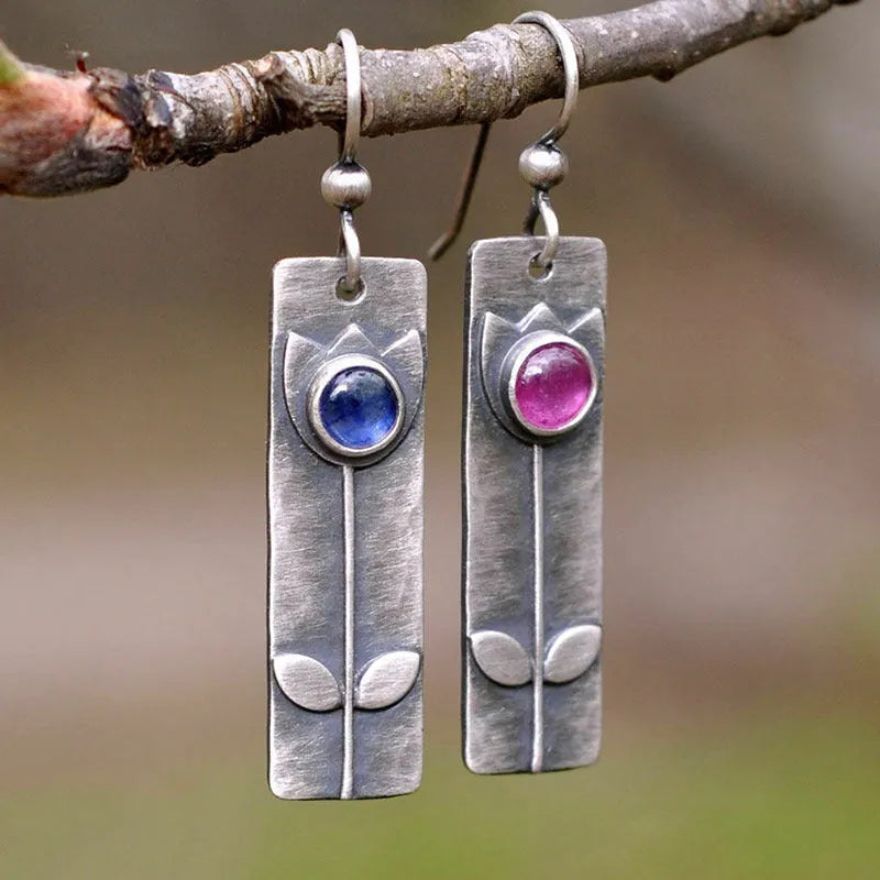 Geometric antique finish red sapphire earrings with elliptical elements and electroplated metal construction