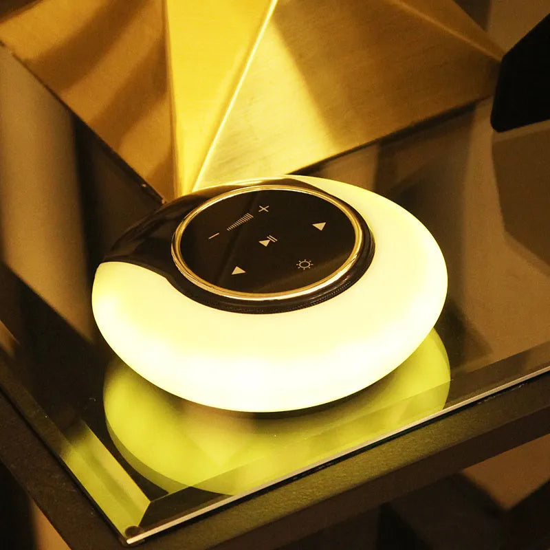 Blue and white Bluetooth speaker with integrated LED lamp showing touch controls and folding design