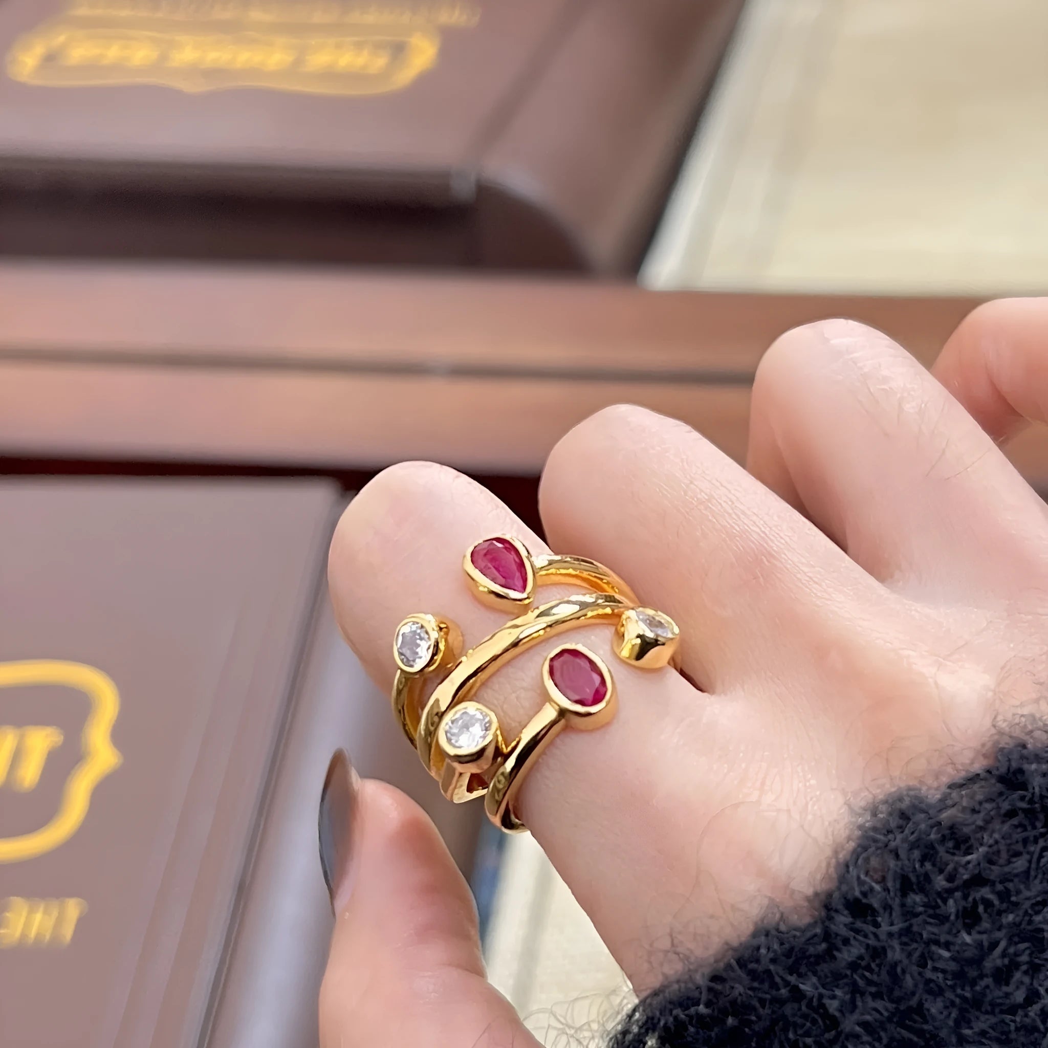 Copper double-headed ring with irregular cross geometric shape and diamond details in two-tone colours.