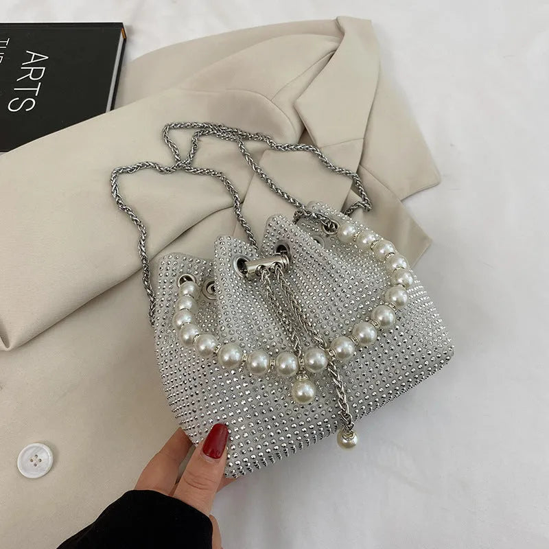 Light diamond PU crossbody shoulder bag with chain strap in bucket shape.