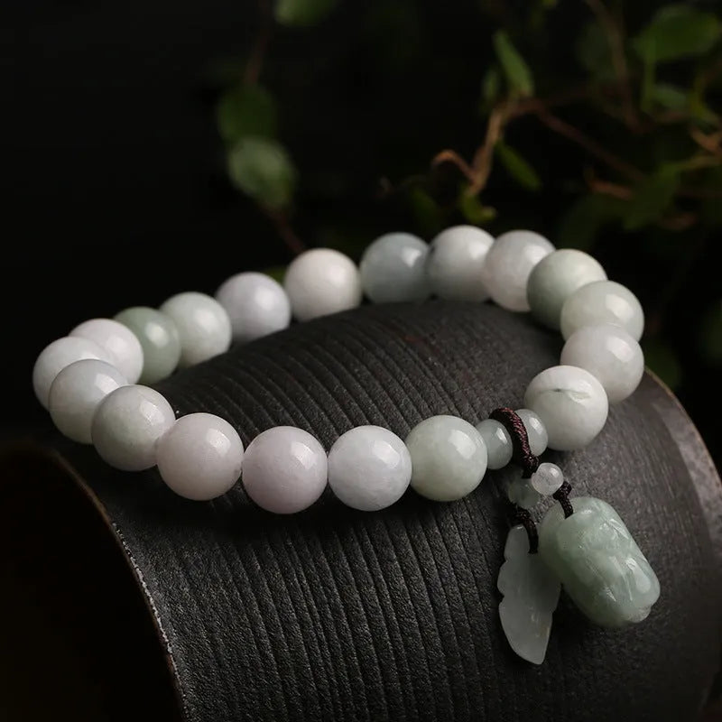 Green jade geometric bracelet with hanging Maitreya Buddha pendant on wrist