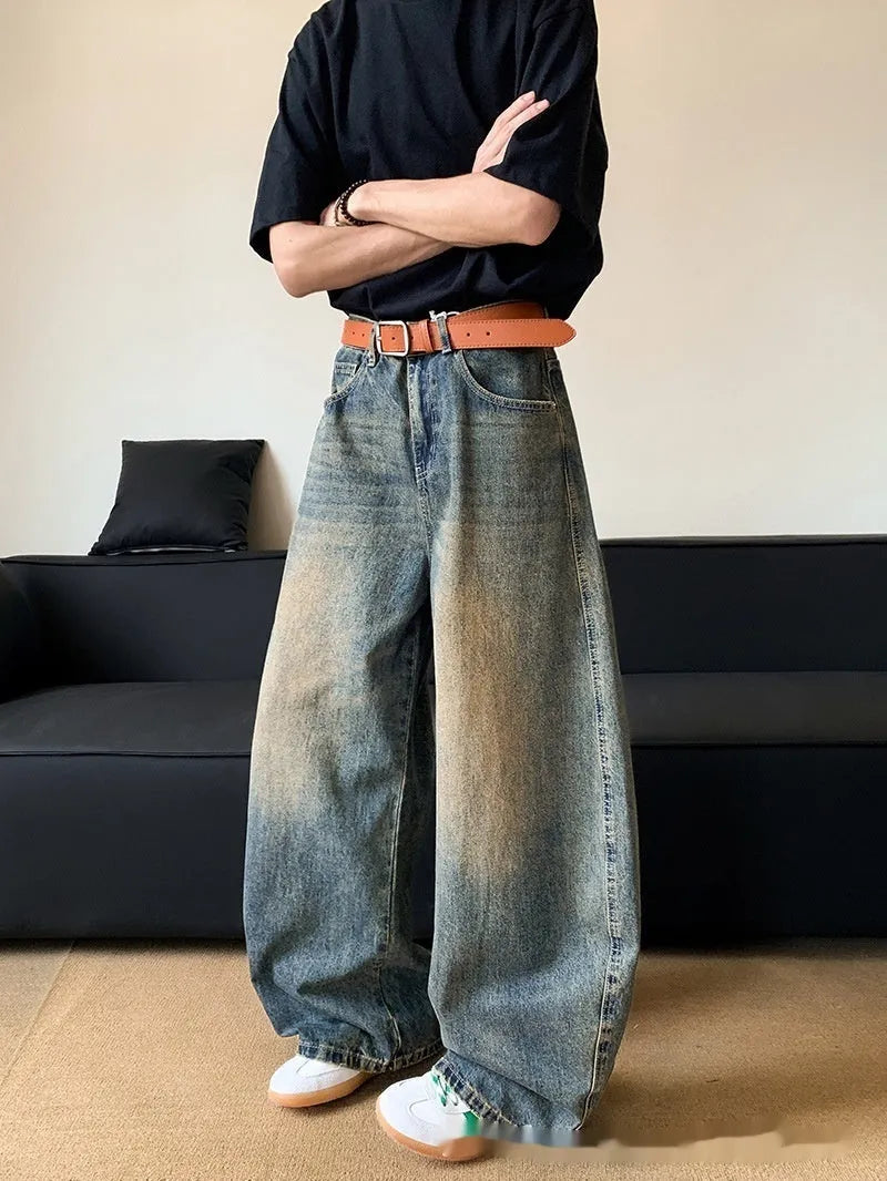 Men's retro blue distressed denim wide-leg trousers showing slim fit and vintage detailing
