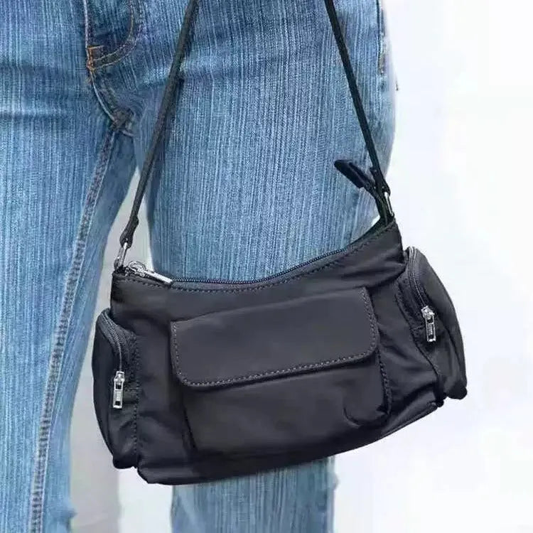 Black nylon lightweight double pocket women's shoulder bag showing side line detail