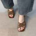 Retro soft leather women's high heel sandals with thin cross straps and an ankle buckle in light brown.