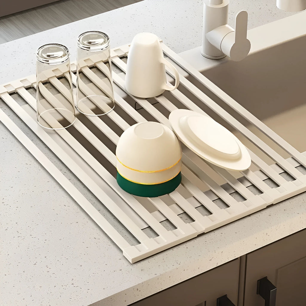 Milky white foldable stainless steel kitchen draining rack over a sink.