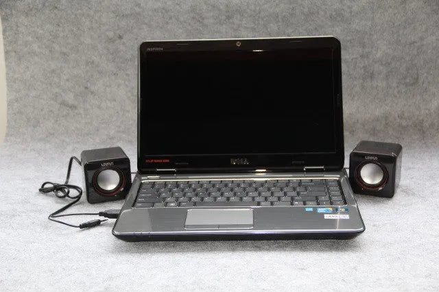 Small black square 2.0 computer speaker with USB power cable for desktop and laptop use.