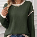 Women's loose-fit knit top with drop shoulders and four leaf clover pattern contrast trim
