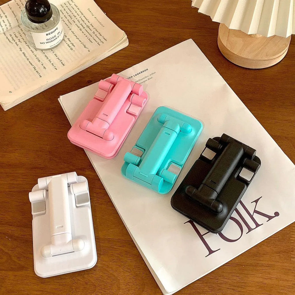 Folding universal plastic mobile phone stand in pearl white, deep black, mint green, and girl pink