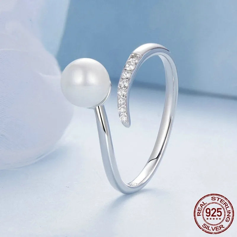 Sterling silver adjustable pearl ring with open loop design showing natural shell pearls on S925 silver band