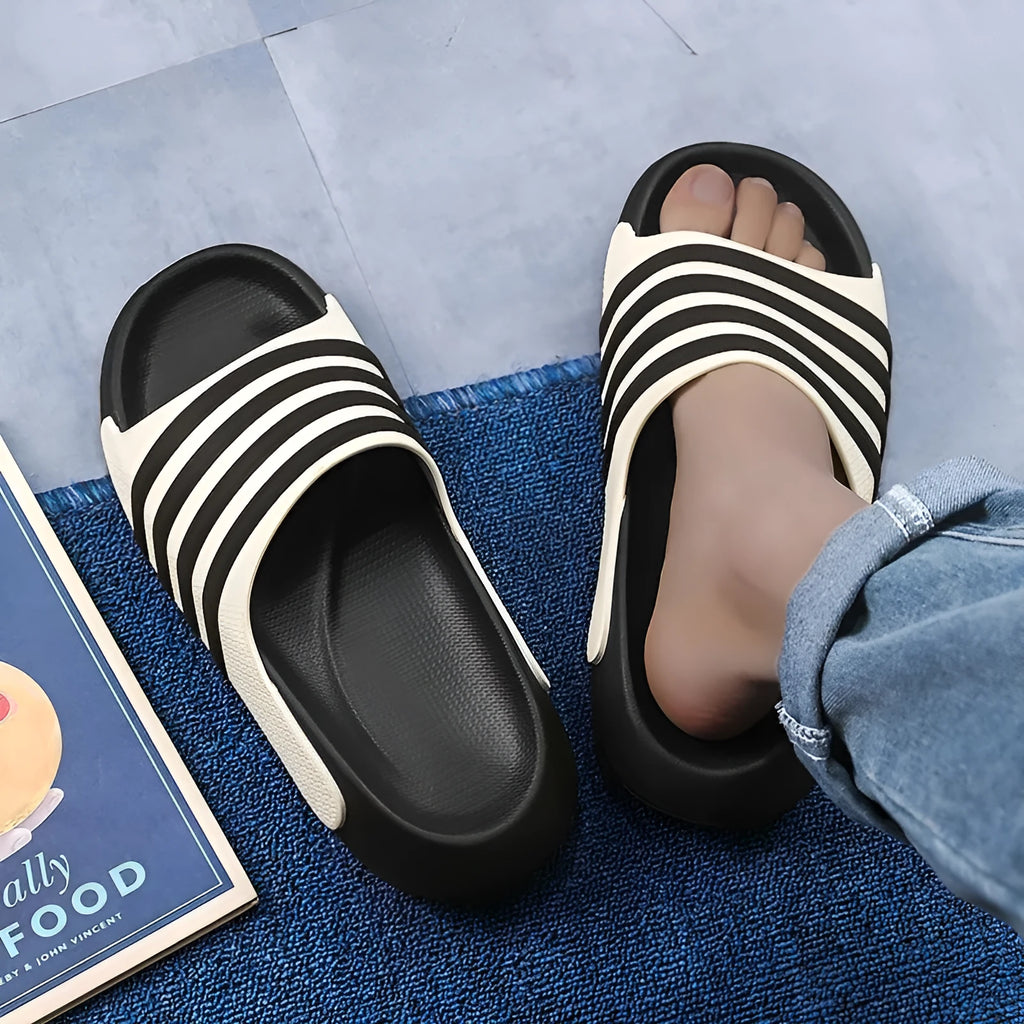 Casual unisex PVC and EVA slippers in beige, black and white, blue and white, and green colours.