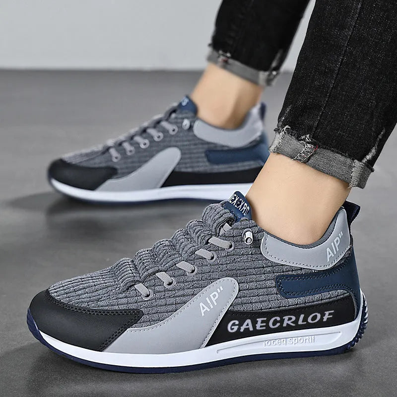 Men's grey and green low-top mesh running shoes with lace-up front.