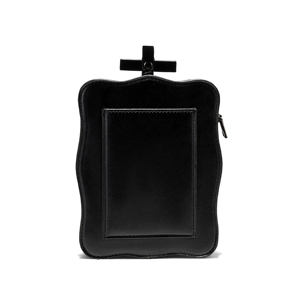 Black gothic mini square messenger bag with skull embossing, stitching, rivets, and chain details on textured PU polyester