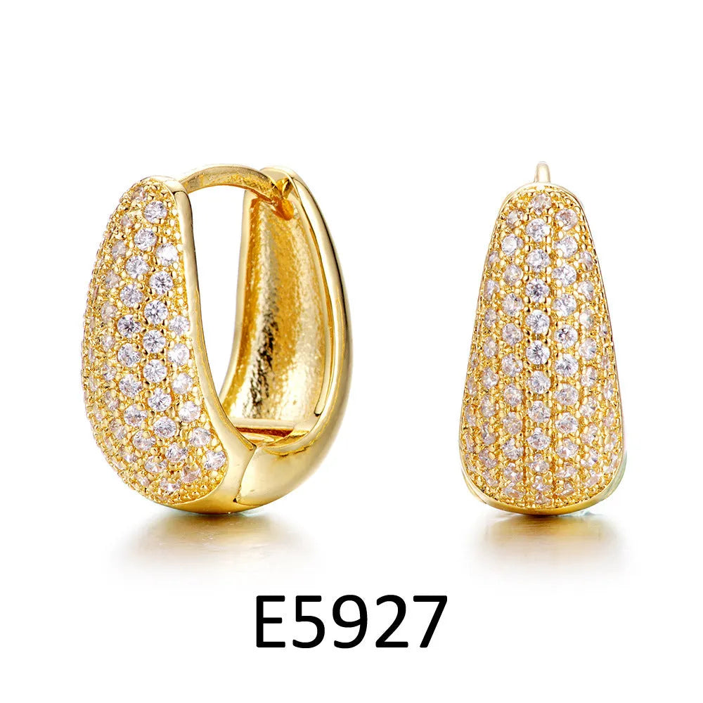 Gold plated heart shaped ear clip earrings with cubic zirconia stones, clip-on back visible