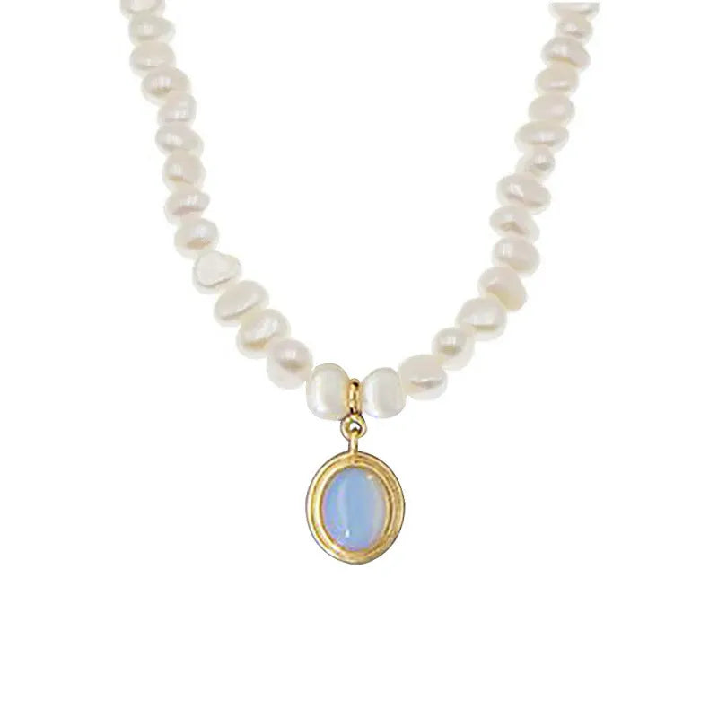 Sterling silver geometric pendant necklace with irregular pearl on adjustable chain.