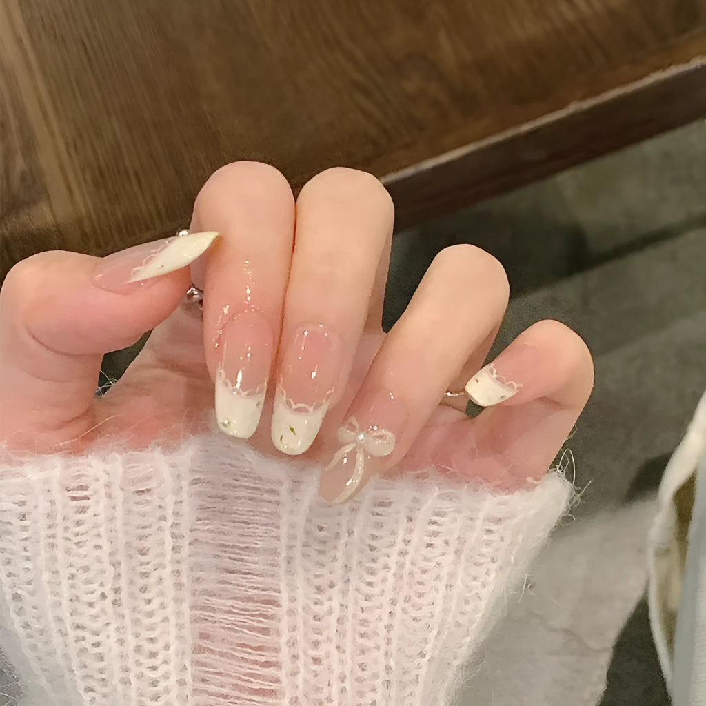 Pack of false nails with assorted nail art designs and adhesive tabs for temporary wear.