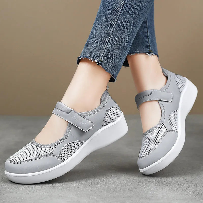 Women's low-top cloth shoes with mesh upper and Velcro strap in grey.