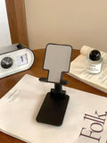 Folding universal plastic mobile phone stand in pearl white, deep black, mint green, and girl pink