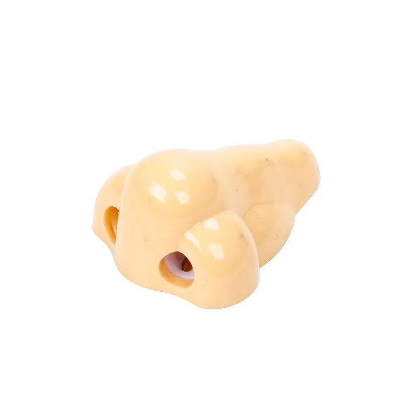 Flesh colour geometric plastic pencil sharpener with big nostril design measuring 58x45x30mm