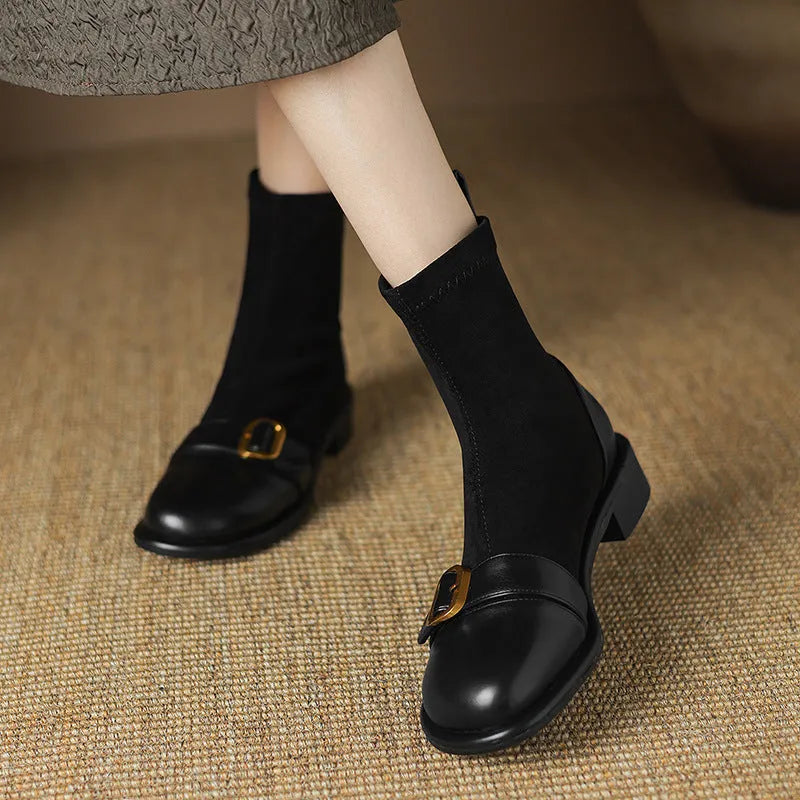 Women's black low heel Martin-style ankle boots with belt buckle stitching and front lace-up fastening.