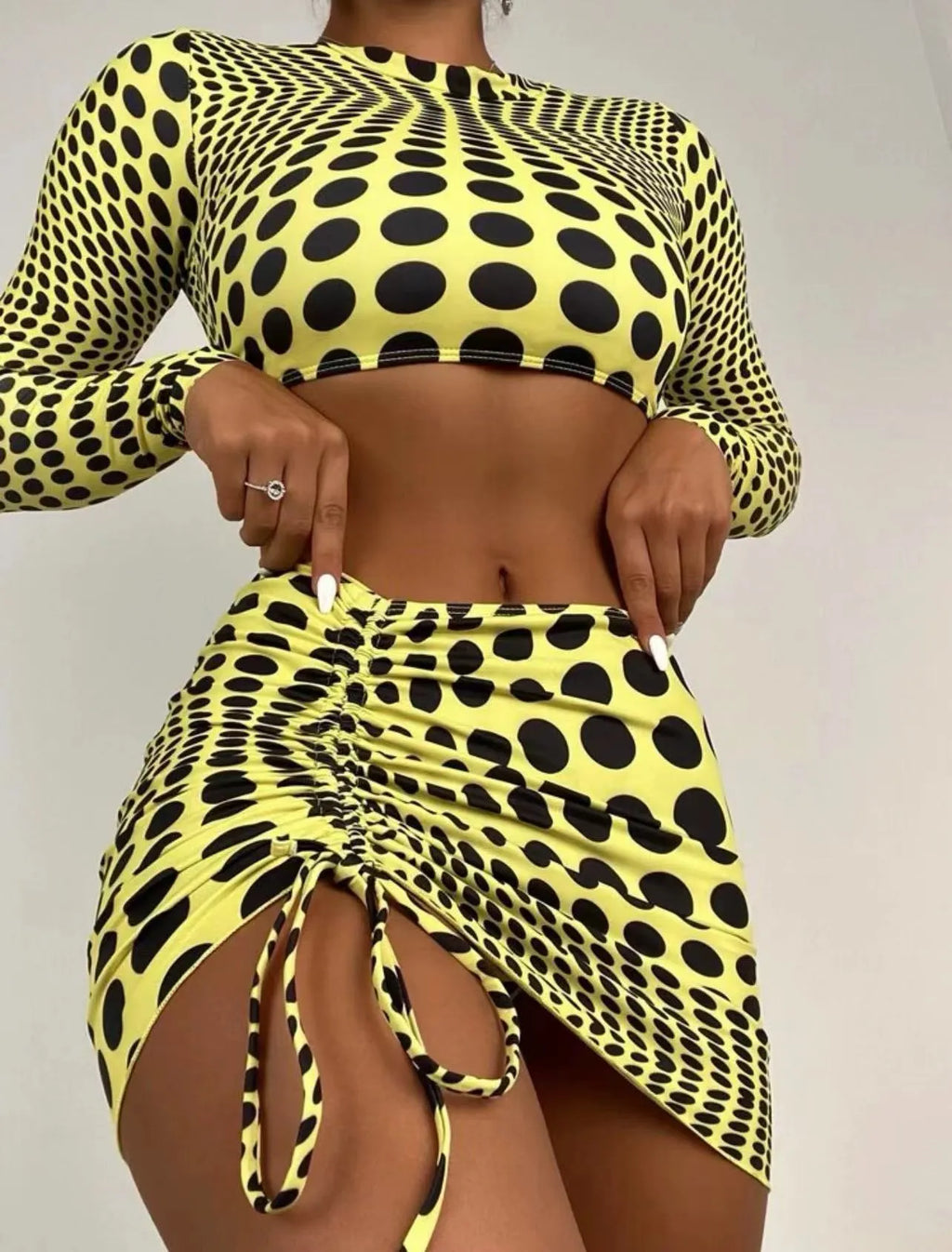Women's green polka dot swimsuit three-piece set showing top, skirt, and bra.