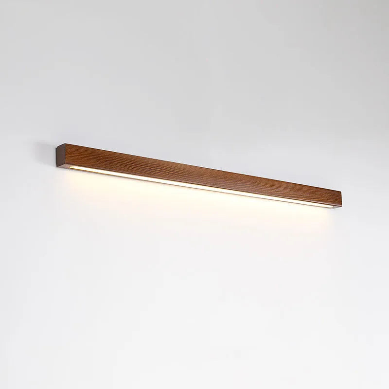 Modern walnut colour wood and acrylic wall lamp with LED lighting in minimalist log strip design