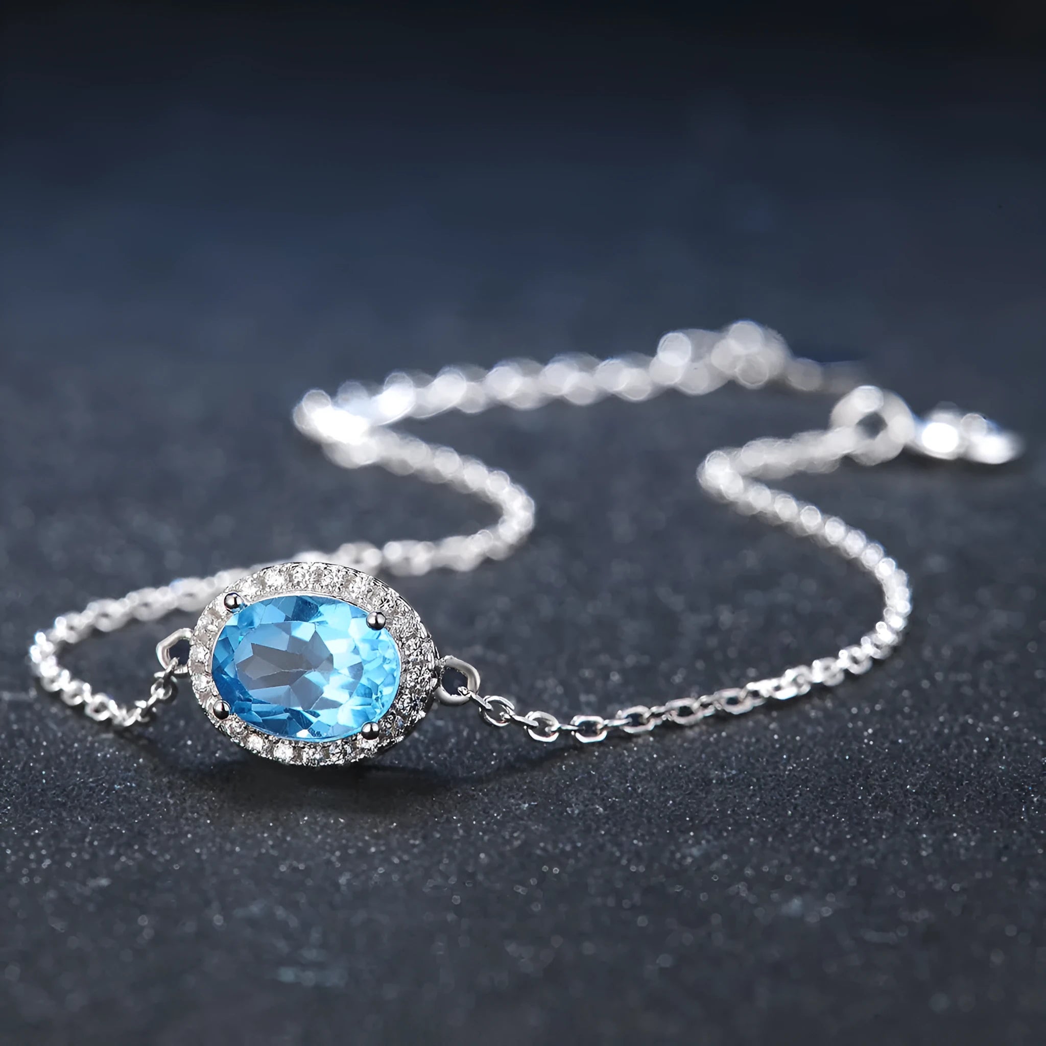 925 sterling silver jewellery set with blue topaz gemstones showing earrings, ring, pendant and necklace